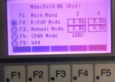 Main menu for the red manifold currently selecting BiPAP mode